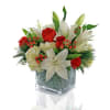 White lilies are the focal flower in this arrangement with roses, hypericum