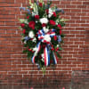 Standing spray with white gladiolas, white fuji mums, white poms, red roses