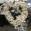 All white easel in a heart shape. Lilies, roses, mums, orchids...