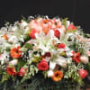 This casket spray make with white lilies , roses, snaps and 