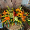 A Grand Display of Fall Blooms Arranged in a Basket.