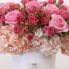 Arrangement includes the folly flowers; hydrangea, spray roses, and roses.