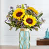 This arrangement with sunflowers and purple limonium make the perfect spring time