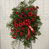 This Sympathy Standing Spray, in beautiful red, is a touching symbol of