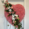 Large solid heart with pink carnations, pink roses and premium greens 