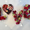A special Valentine&rsquo;s Day arrangement filled with roses, spray roses, orchids, and