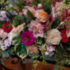 This lovely spray is designed using a variety of garden style flowers.
