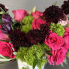 This floral design is a favorite! Flowers are arranged in a cylinder