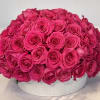 Beautiful arrangement featuring, Hot Pink Roses Arrange in a large container.