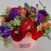 A mixture of bright colors of blooms designed in a chic box
