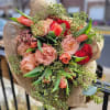 Peach roses, orange tulips, garden roses, seeded eucalyptus