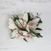 Desktop arrangement filled of beautiful white Cymbidium orchids 