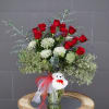 Long-stem Ecuadorian red roses and accents in a tall glass vase with
