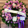 A full wreath designed in shades of pinks, purples and touches of