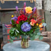 An outstanding farm fresh mixture of rich jewel colored flowers.  