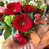 FESTIVE COLORED ROSES, GERBRA DAISY  AND HYDRANGEA DESIGNED IN A GLASS
