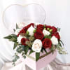 This special arrangement consists of roses and a variety of greens all
