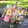 Natural and organic garden like arrangement of seasonal light pastel flowers, always
