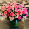 A chic and elegant arrangement full of roses large and small in