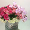 Elegant pink arrangement of hot pink roses, white hydrangea, and a splash