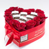 A heart-shaped box with red  roses is very unusually complemented by