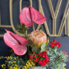 This tropical arrangement is like a heat wave in a vase! It