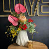 This tropical arrangement is like a heat wave in a vase! It