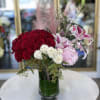 Love All consists of Red Roses, Stargazer Lilies, Pink Hydrangeas, wax flowers