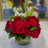 This arrangement is consisting of red roses, white lilies, green coffee beans