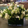 Custom arrangement of white tulips, white roses, white spray roses, white orchids