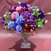 Custom arrangement of calla lilies, wax flower, lisianthus, hydrangea, blue hyacinth, pink