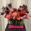 This fun and colorful design has imported Ecuadorian roses and a mix