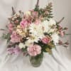 Feminine and pretty vase arrangement with pink roses, alstroemeria, carnations, and wax