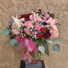 Beautiful pink and red arrangment featuring hydrangeas, large and spray roses, dianthus