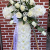 An all white tribute, this white cross funeral spray is pure and