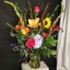 This multicolored floral extravaganza includes roses, hydrangea, sunflowers, and blue delphinium. One