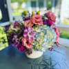 Compact and round arrangement that is timeless and classy for any occasion.