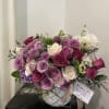 Beautiful Ivory and lavender roses, lush greens arranged with other premium and