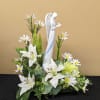 This Angel of Comfort sits among fresh white lilies, white daisies, green