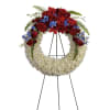 An elegant ring of serene white flowers topped with bold red and