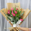 Dozen of seasonal tulips wrapped with eucalyptus and other greens tide with