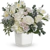This peaceful arrangement includes white hydrangea, white roses, white spray roses, white