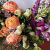Bursting with birthday cheer!
This fun bouquet features peach ranunculus, burgundy snapdragon, assorted