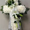 A solid White cross of Carnations with White Oriental lilies breaking thru