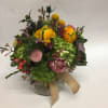 This short arrangement comes complete with blue sea thistle, green hydrangea, billy