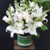 Mixture of white flowers including Rose, snapdragon and lilies on cylinder vase