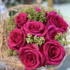 Pink roses with lovely garnishes in the birds nest type bouquet. 
