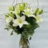 This arrangement of white lilies and curly willow is a graceful way