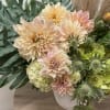 Mixture of dahlias, roses and tulips accented with wild flowers and greens