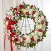 Our timeless standing wreath&mdash;symbolizing the circle of life&mdash;features red roses and Stargazer